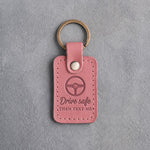 Rose pink leather keychain debossed with a steering wheel above Drive safe and THEN TEXT ME