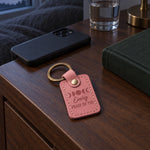 Pink Every Phase of You keychain held in an open palm beside a small anniversary card in warm evening light