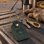 Hank Farmer keychain in green leather on pickup keys resting on a fence post at the edge of a cornfield