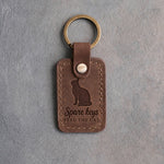 Sicilian brown leather keychain debossed with a cat looking up above the words Spare keys and FEED THE CAT