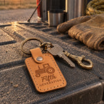 Fifth Generation keychain in golden tan leather on farm truck keys lying on a weathered barn workbench