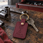 Wine red Fires on ALL CYLINDERS keychain on car keys tucked into a greeting card on a kitchen table