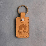 Indian Summer golden tan leather keychain debossed with a gabled house above First home and EST 2026