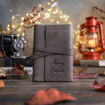 Country gray leather wrap journal with its strap tied, the lower cover debossed with a dry fly above Owen and FISHING LOG