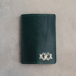 Forest Green leather passport cover with the vine monogram MHR in the bottom corner