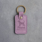 Lilac leather keychain debossed with a dachshund and the words Forever SINCE 3·14·24, on gray concrete