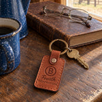 Fourth GENERATION ranch brand keychain in Arizona leather on a ranch kitchen table next to a speckled enamel coffee pot