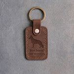 Sicilian brown leather keychain debossed with a German Shepherd silhouette above Best friend and THE SHEPHERD, on gray concrete