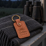 Caramel Golden Hour keychain clipped to a camera bag strap in warm low sunset light