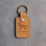 Indian Summer tan leather keychain with a debossed golden retriever above Best friend and THE GOLDEN, on gray concrete