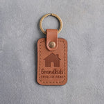 Caramel leather keychain debossed with a gabled house above Grandkids and SPOILED HERE