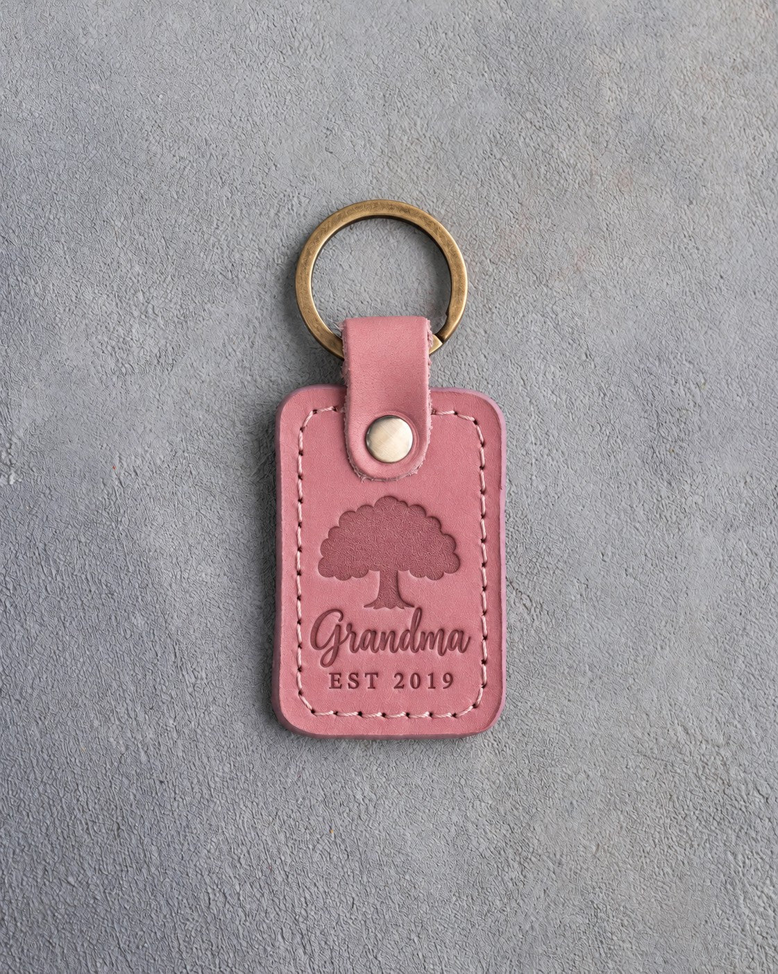 Parisian Blossom pink leather keychain debossed with a solid oak tree above Grandma and EST 2019