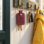 Wine red Grandma's HOUSE RULES keychain on a key ring next to a cookie jar