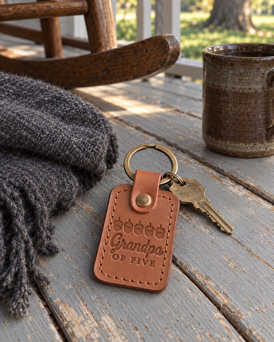 Caramel Grandpa OF FIVE keychain on truck keys on a picnic table at a family reunion