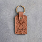Caramel leather keychain debossed with crossed wrenches above Grandpa's and GARAGE