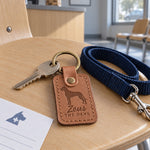Zeus the Dane keychain in caramel leather with house keys on a sunny windowsill