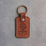 Arizona orange tan leather keychain debossed with a soccer ball and the words Halftime ORANGE SLICES, on gray plaster