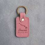Parisian Blossom pink leather keychain debossed with the Hawaiian island chain and a heart off Oahu above Hawaii and RAISED ME, on gray concrete