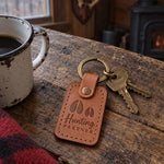 Two Hunting Partner keychains in caramel leather on two key rings lying together on a tailgate at dawn