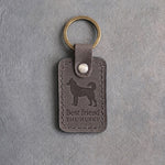 Country gray leather keychain debossed with a Siberian Husky silhouette above Best friend and THE HUSKY, on gray concrete