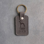 Country gray leather keychain debossed with an Italian Greyhound silhouette and the words Iggy DAD, on gray concrete