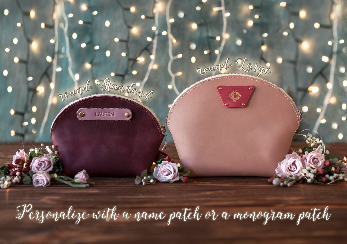 Two round makeup bags in sangria and blush showing name-patch and monogram-patch options
