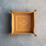 Indian Summer leather valet tray with snapped corners and the initials CHB pressed into the diamond frame, seen from above