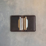 Open leather card wallet showing the card slots and cash pocket