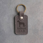 Country gray leather keychain debossed with an Irish Wolfhound silhouette and the words Wolfhound DAD, on gray concrete