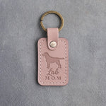Blush pink leather keychain debossed with a Labrador Retriever silhouette and the words Lab MOM, on gray concrete