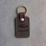 Dark espresso leather keychain debossed with a largemouth bass above Largemouth and BASS, on gray concrete