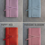Leather journals in Lilac, Turquoise, Poppy Red and Parisian Blossom on grey plaster