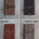 Leather journals in Sicilian Brown, Dark Espresso, Arizona and Country Gray on grey plaster