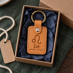 Golden tan Leo keychain on car keys resting on a summer beach towel in bright afternoon sun
