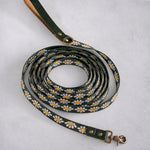 Long dog leash in Lilac Daisy woven webbing, coiled, with a green leather handle
