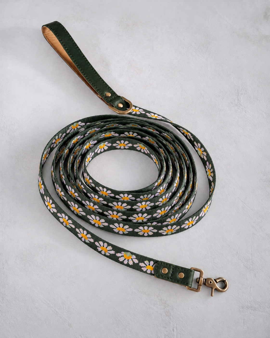 Long dog leash in Lilac Daisy woven webbing, coiled, with a green leather handle