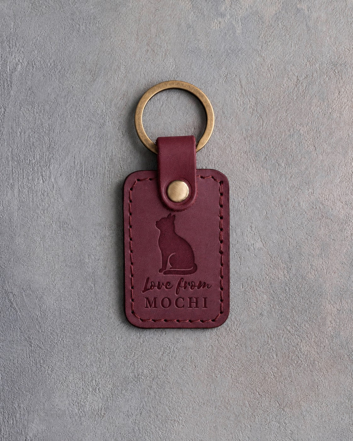 Sangria red leather keychain debossed with a cat looking up above the words Love from and the name MOCHI