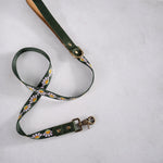 Woven webbing dog leash, Lilac Daisy design (lilac daisies on forest green), with a leather handle
