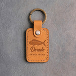 Indian summer leather keychain debossed with a mahi mahi above Dorado and MAHI MAHI, on gray concrete