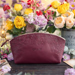 Sangria burgundy floral-embossed leather makeup pouch personalized with the name Grace