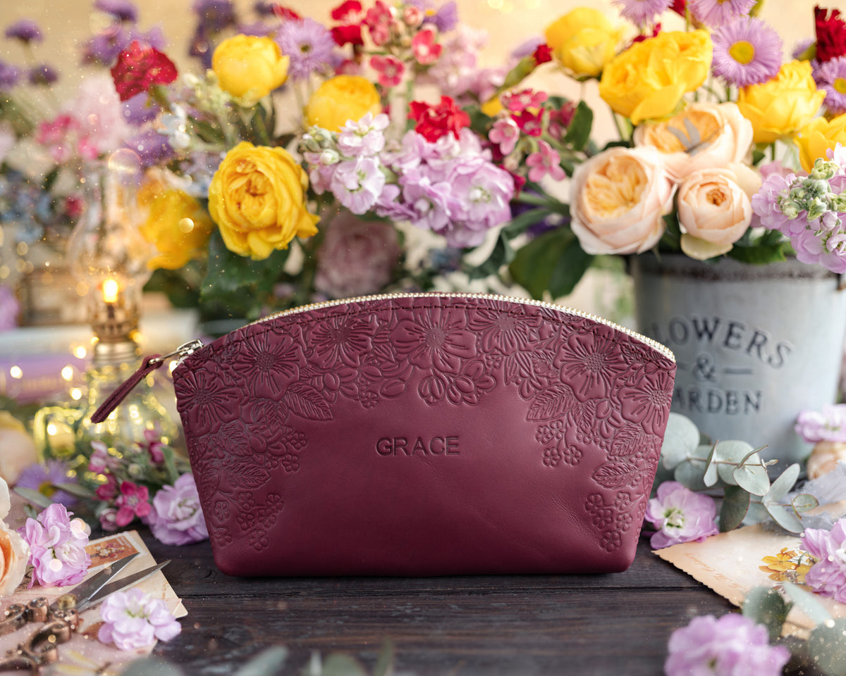 Sangria burgundy floral-embossed leather makeup pouch personalized with the name Grace