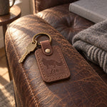 Leo MAINE COON keychain in brown leather hanging from house keys beside a large cat tree
