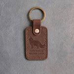 Sicilian brown leather keychain debossed with a standing Maine Coon cat above Life with a and MAINE COON, on gray concrete