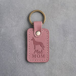 Parisian Blossom pink leather keychain with a debossed Malinois and the words Mal MOM, on gray concrete