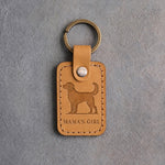 Indian Summer tan leather keychain debossed with an alert standing dog above MAMA'S GIRL, on gray concrete