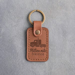 Caramel leather keychain debossed with a semi truck tractor above Million mile and DRIVER