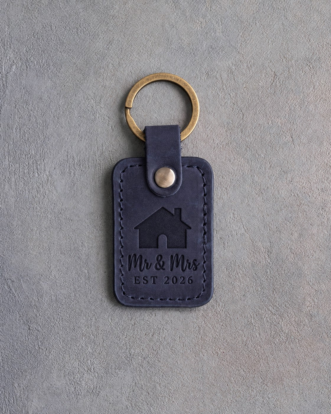 Blueberry navy leather keychain debossed with a gabled house above Mr & Mrs and EST 2026