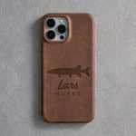 Back of a sicilian brown leather iPhone case debossed with a musky above Lars and MUSKY below the camera, on gray plaster