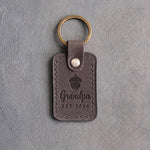 Country gray leather keychain debossed with a single acorn above Grandpa and EST 2026