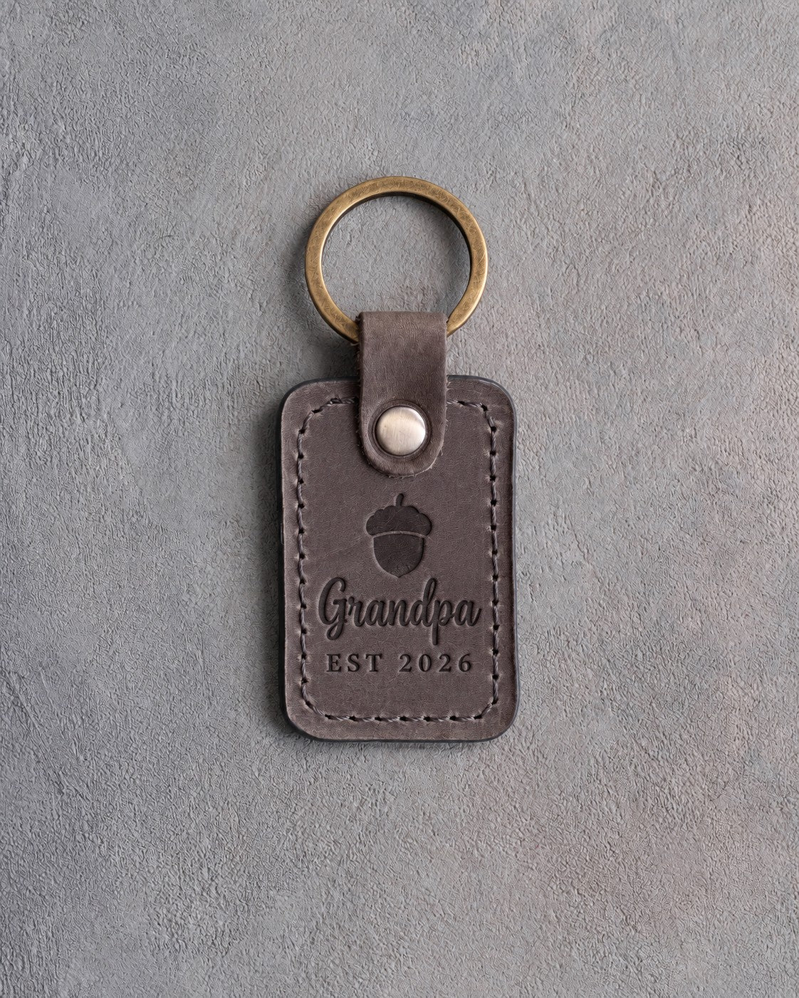 Country gray leather keychain debossed with a single acorn above Grandpa and EST 2026